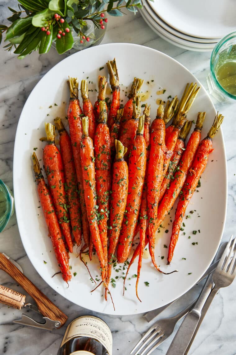 Glazed Carrots - Honey glazed carrots roasted to perfection, tossed in butter + fresh herbs. The easiest (and tastiest) side dish to any meal!