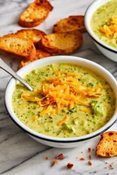 A creamy broccoli cheddar soup, topped with cheddar cheese and seasoned with salt and pepper.