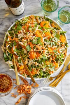 A rotisserie chicken salad with romaine lettuce, mandarin oranges, cilantro, onions, cashews and a sesame ginger dressing.