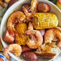 Unpeeled shrimp, corn, sausage, and baby potatoes cooked in a garlicky, lemony beer broth and served with bread.