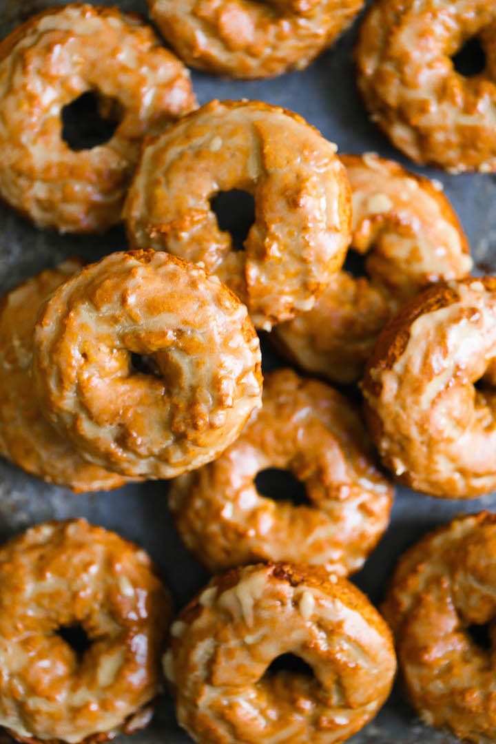 Baked Pumpkin Donuts with Maple Glaze - These are the best Fall pumpkin donuts ever. So soft, so crumbly and so perfectly smothered in a warm maple glaze!