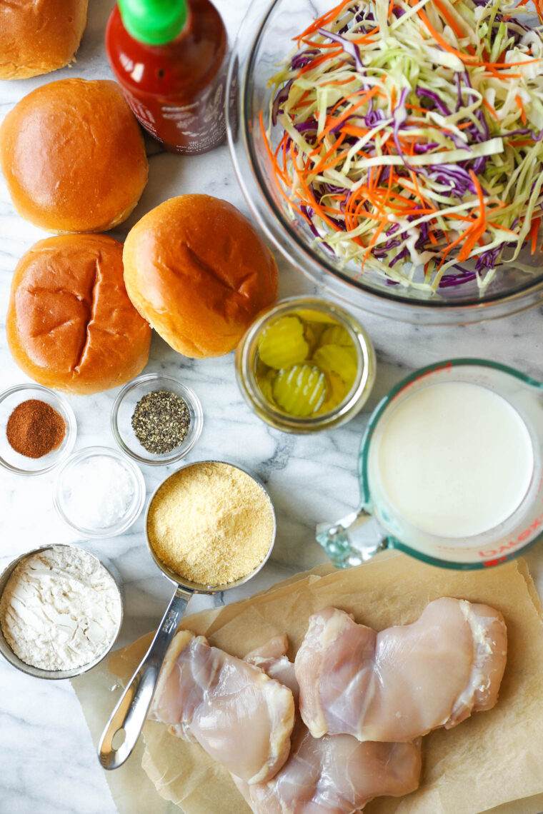 Fried Chicken Sandwiches - KILLER buttermilk fried chicken thighs! So crispy, so juicy. Served with Sriracha mayonnaise, coleslaw and pickles!