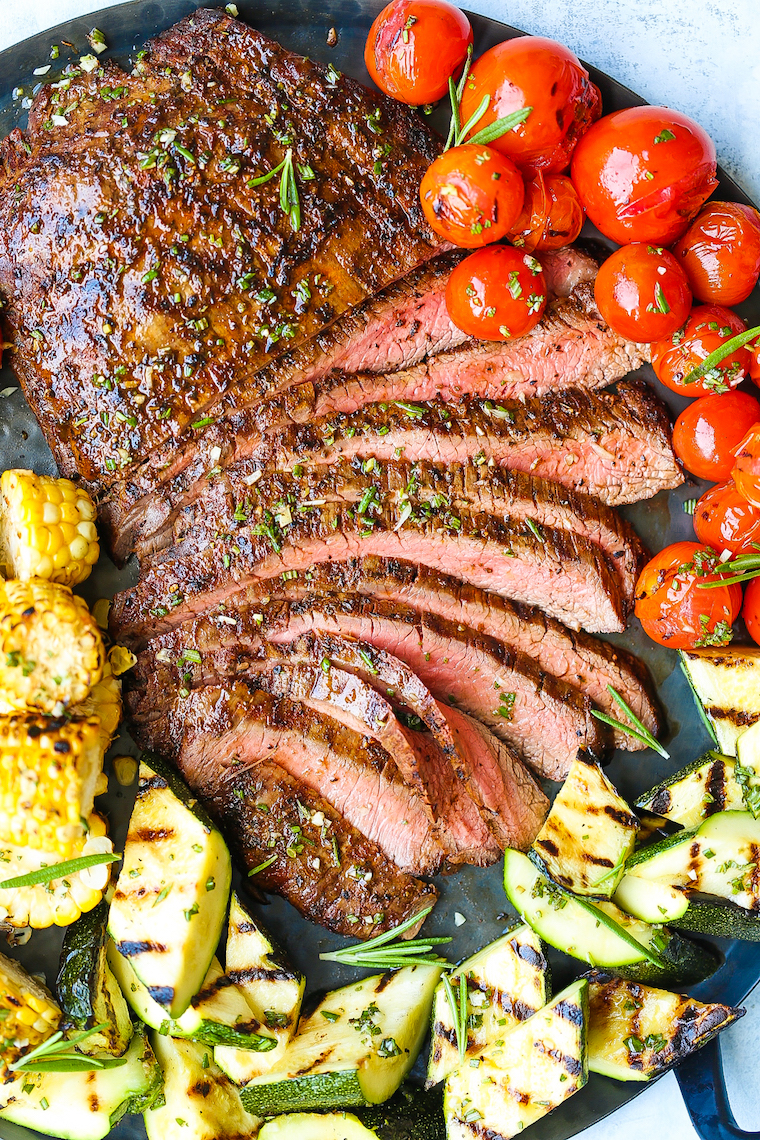 Grilled Flank Steak and Vegetables - The BEST + EASIEST tender flank steak ever! Paired so perfectly with crisp-tender grilled corn, zucchini and tomatoes!