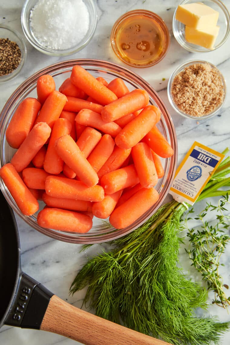 Honey Glazed Baby Carrots - The sweet + sticky honey glaze makes these baby carrots completely irresistible in this easy 15-minute side dish!