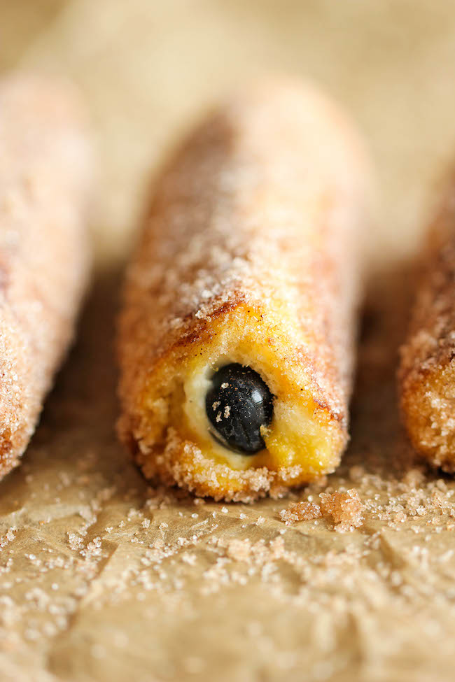 Blueberry French Toast Roll Ups - A fun twist on French toast stuffed with cream cheese and blueberries, tossed in cinnamon sugar goodness!