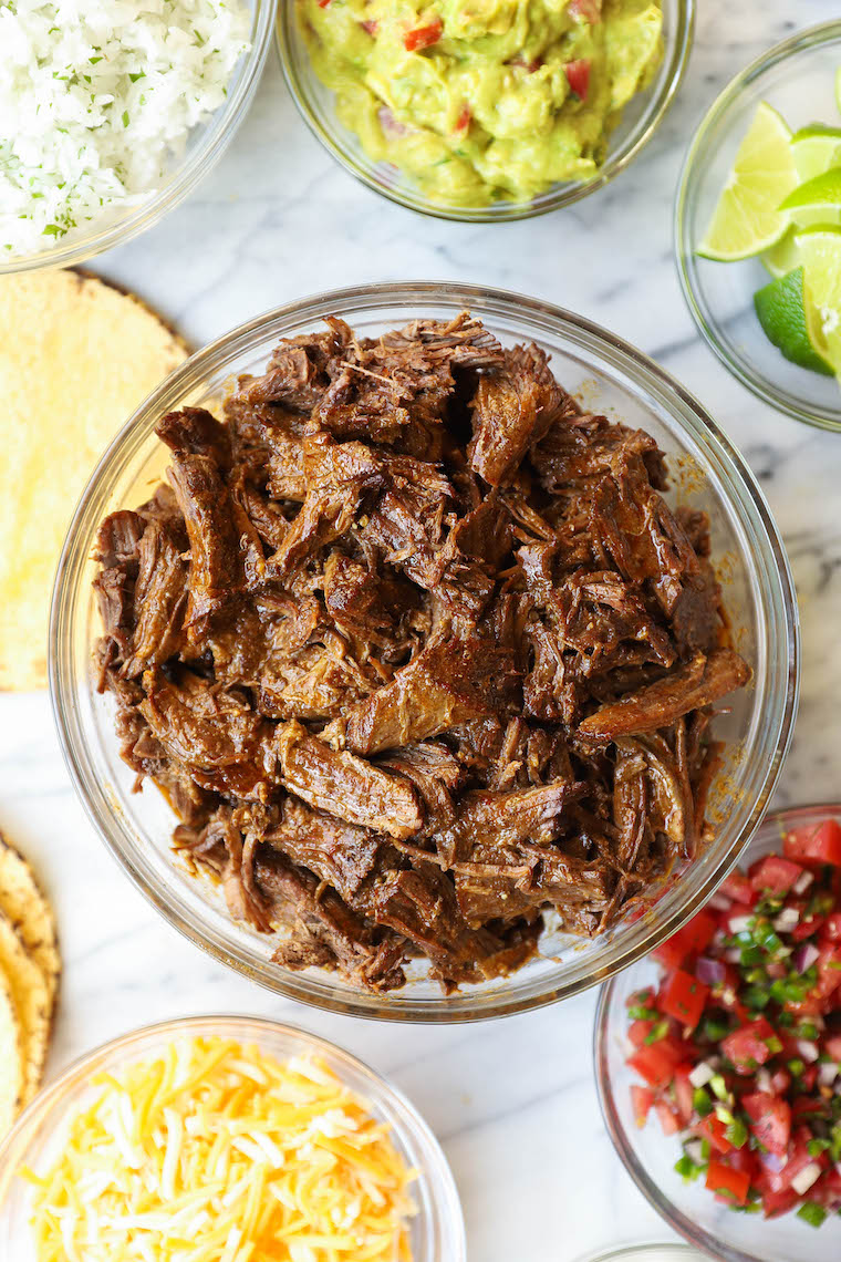 Slow Cooker Beef Barbacoa - So easy and so flavorful! Cooked low + slow in the crockpot. Perfect for tacos, burritos, quesadillas, and more!