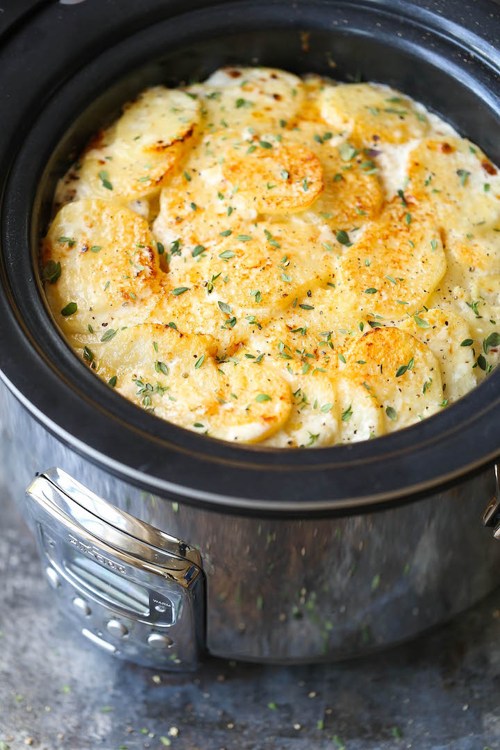 Slow Cooker Cheesy Scalloped Potatoes - This crockpot version of scalloped potatoes is so EASY, creamy, tender and cheesy! And it frees up your oven space!