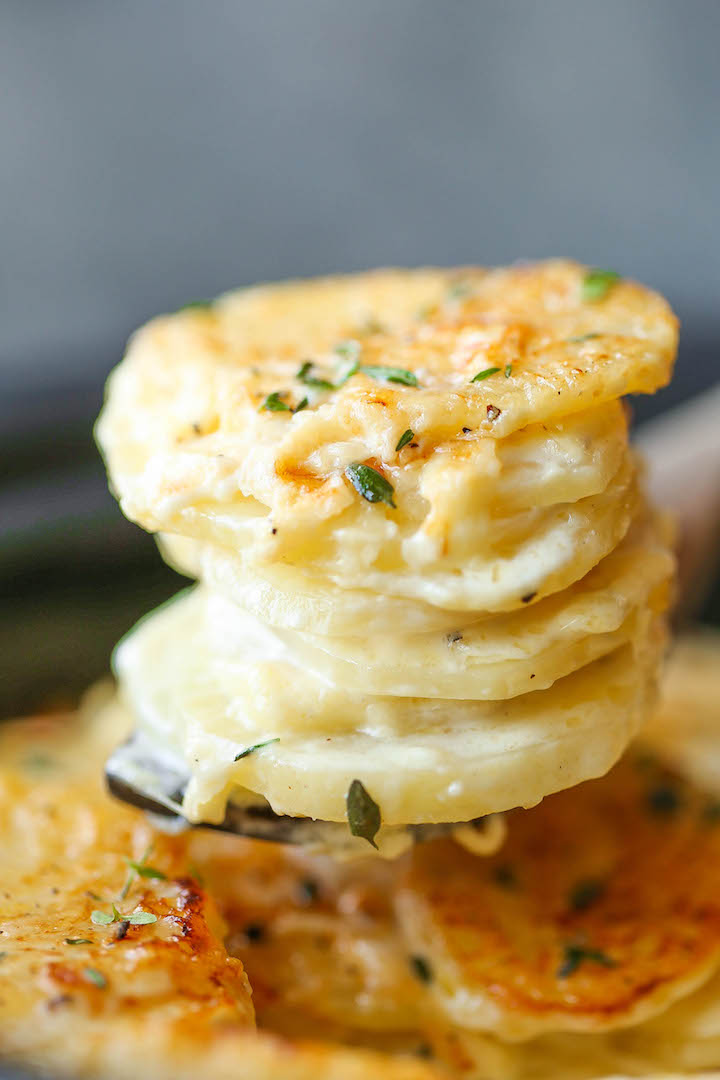 Slow Cooker Cheesy Scalloped Potatoes - This crockpot version of scalloped potatoes is so EASY, creamy, tender and cheesy! And it frees up your oven space!